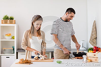 Couple cooking food at home kitchen Stock Photo