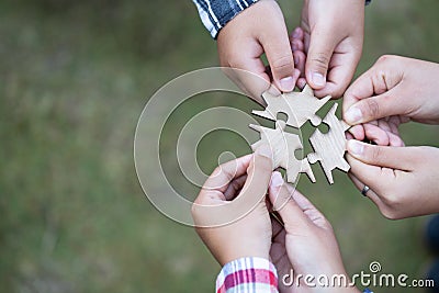 People helping in assembling puzzle, cooperation in decision making, team support in solving problems and corporate group teamwork Stock Photo