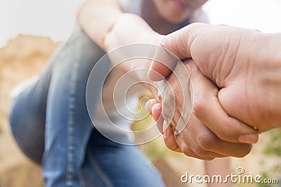 People helping each other hike up a mountain, Giving a helping h Stock Photo