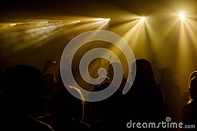 People in highlighted golden mist Stock Photo