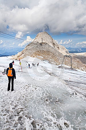 People hiking on Gjaidstein Mountain adventure trail near Dachstein glacier on August 17, 2017 in Ramsau am Dachstein, Austria. Editorial Stock Photo