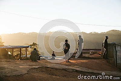 People are on the hill when the sun is going down at golden hour in the Akha village of Maejantai on the hill in Chiang Mai. Editorial Stock Photo