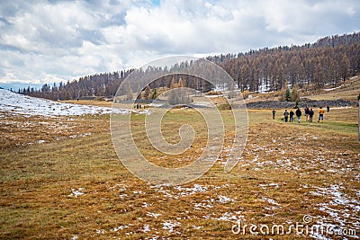 People on historic Kurgan or tumulus, grave mound in Tschuja Steppes, Altai Republic, Siberia, Russia Stock Photo