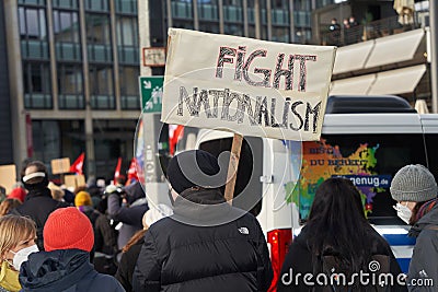 People hold up a sign with the text `Fight Nationalism` Editorial Stock Photo