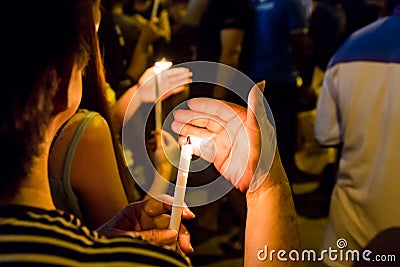 People holding candle vigil in darkness seeking hope, worship, p Stock Photo