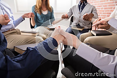 People Holding Each Others Hand Praying Together Stock Photo
