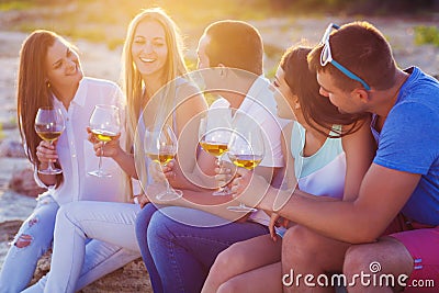 People holding glasses of white wine at the beach picnic Stock Photo