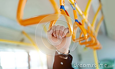 People holding handle on train Stock Photo