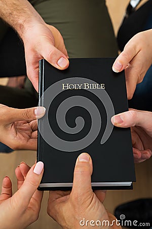 People Holding Holy Bible Stock Photo