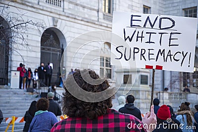 People holding signs supporting Asians in order to protest against the white supremacy in Portland Maine Editorial Stock Photo