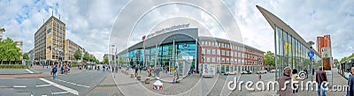 people hurry to train station with its modern glass facade construction in Munster, Germany Editorial Stock Photo