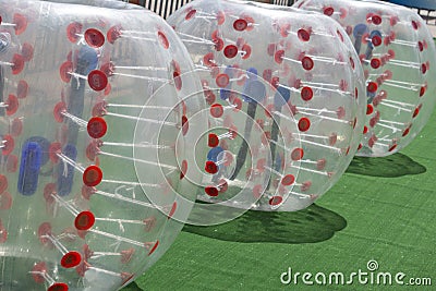 People in an inflatable ball play bumperball Stock Photo