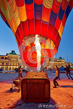 People inflate a huge balloon with a basket Editorial Stock Photo