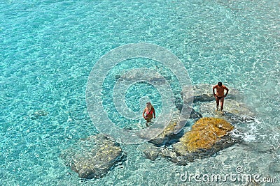 02.09.2018. People inside paradise clear torquoise blue water in Favignana island, Cala Azzura Beach, Sicily South Italy. Editorial Stock Photo