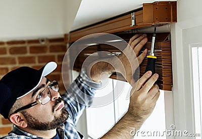 People installing window curtain apartment Stock Photo