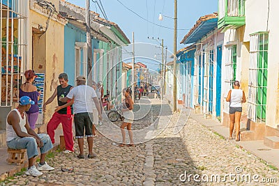 People interacting in typical village street in Cuba Editorial Stock Photo