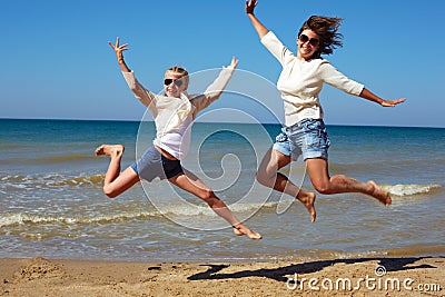 People are jumping against the background of the sea. Stock Photo