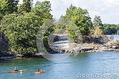 People kayaking in Wanderers Channel, Admiralty group, 1000 islands, Canada Editorial Stock Photo