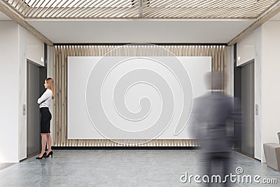 People and large horizontal poster in office lobby Stock Photo