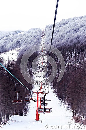 People on the lift enjoy the stunning view of the famous greek ski center Editorial Stock Photo