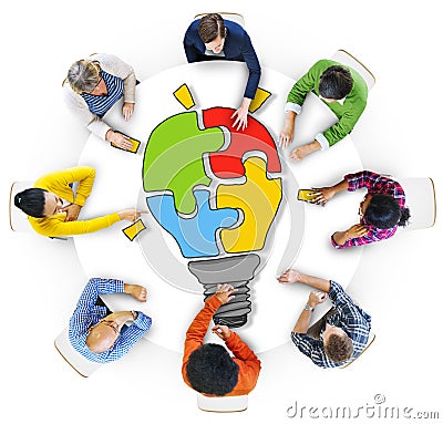 People with Light Bulb Jigsaw Puzzle Forming Stock Photo