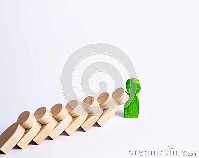 People in line fall like dominoes. green man stops the fall of people as dominoes. The concept of durability and strength Stock Photo
