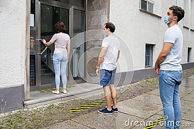 People Line With Social Distancing Protocol Stock Photo