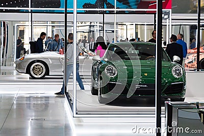 People looking at Porsche sports cars standing at Volkswagen Group forum Drive in Berlin, Germany Editorial Stock Photo