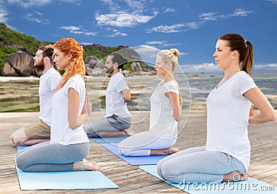 People making yoga in hero pose outdoors Stock Photo