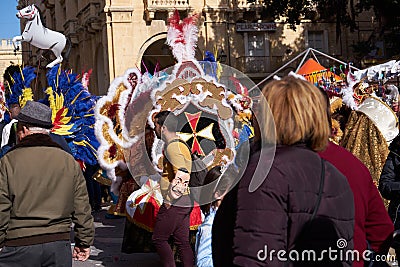 Annual Mardi Gras Fat Tuesday grand parade on maltese street of allegorical floats and masquerader procession Editorial Stock Photo