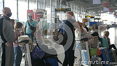 People in medical masks from coronavirus wait in line to check in for a flight in Bangkok Suvarnabhumi airport Editorial Stock Photo