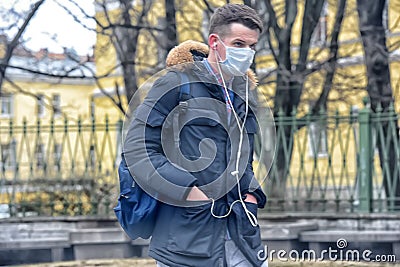 People in medical masks on the streets of the city during the coronavirus epidemic Editorial Stock Photo