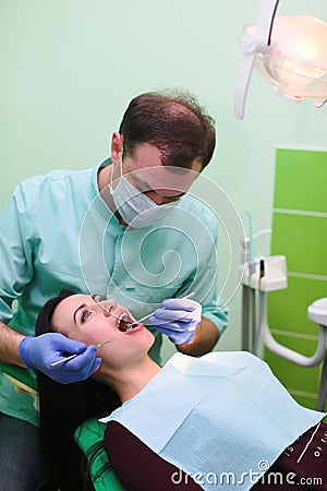 People, medicine, stomatology and health care concept - close up of dentists and assistant with mirror Stock Photo