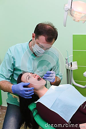 People, medicine, stomatology and health care concept - close up of dentists and assistant with mirror Stock Photo