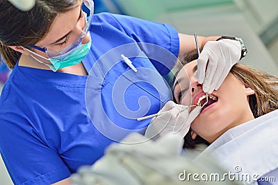 People, medicine, stomatology and health care concept - happy female dentist checking patient girl teeth Stock Photo