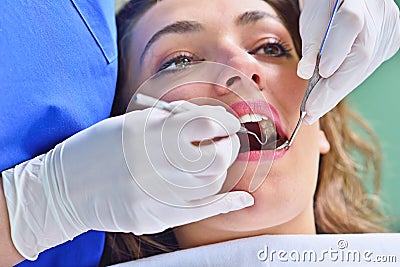 People, medicine, stomatology and health care concept - happy female dentist checking patient girl teeth Stock Photo
