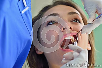 People, medicine, stomatology and health care concept - happy female dentist checking patient girl teeth Stock Photo