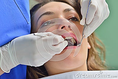 People, medicine, stomatology and health care concept - happy female dentist checking patient girl teeth Stock Photo