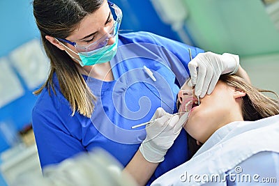 People, medicine, stomatology and health care concept - happy female dentist checking patient girl teeth Stock Photo