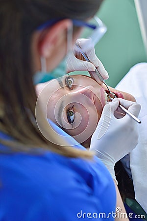 People, medicine, stomatology and health care concept - happy female dentist checking patient girl teeth Stock Photo