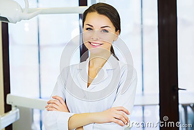 People, medicine, stomatology and healthcare concept - happy young female dentist with tools over medical office background Stock Photo