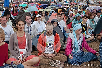 People meditating in a city park Editorial Stock Photo
