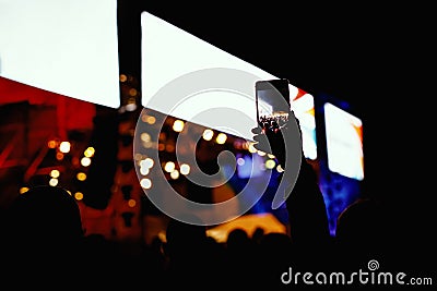 People with mobile phone in hands shooting concert event Stock Photo