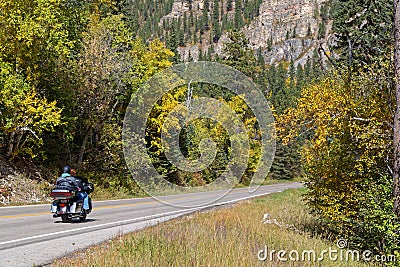 People on a motorbike i nSpearfish Canyon at fall Editorial Stock Photo