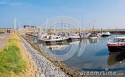 People, motorboats and sailboats in marina of West Frisian island Schiermonnikoog, Netherlands Editorial Stock Photo