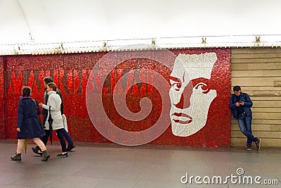 People move past the portrait of the famous poet Mayakovsky, Mayakovskaya metro station Editorial Stock Photo