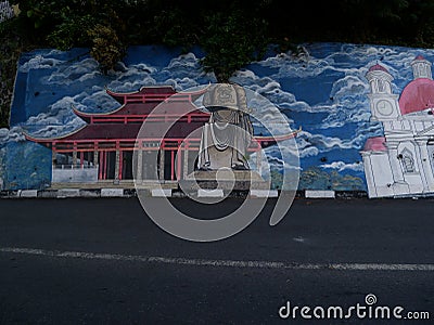 People move through the road with the mural of Semarang's cultural icon located on the Sumbing road. Editorial Stock Photo