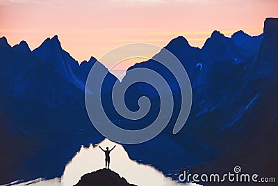 People and nature, silhouette of person with raised hands on beautiful mountain landscape Stock Photo