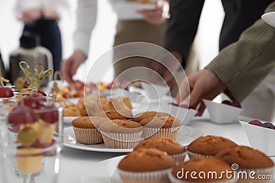 People near table with different delicious snacks during coffee break, closeup Stock Photo