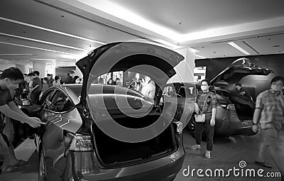 People with new electric vehicle cars in showroom of Shopping center Bangkok Editorial Stock Photo